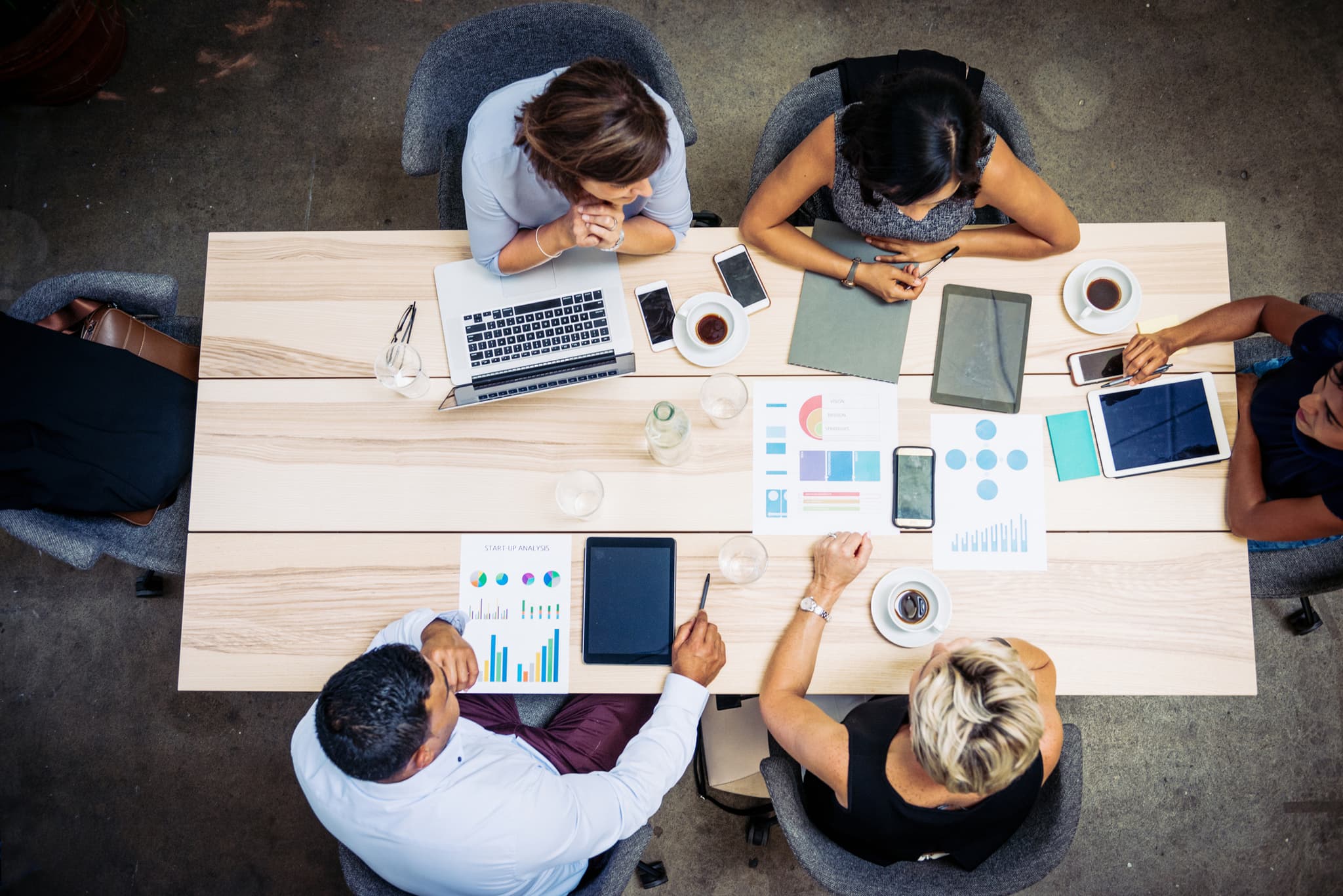 Coworkers around a board room table